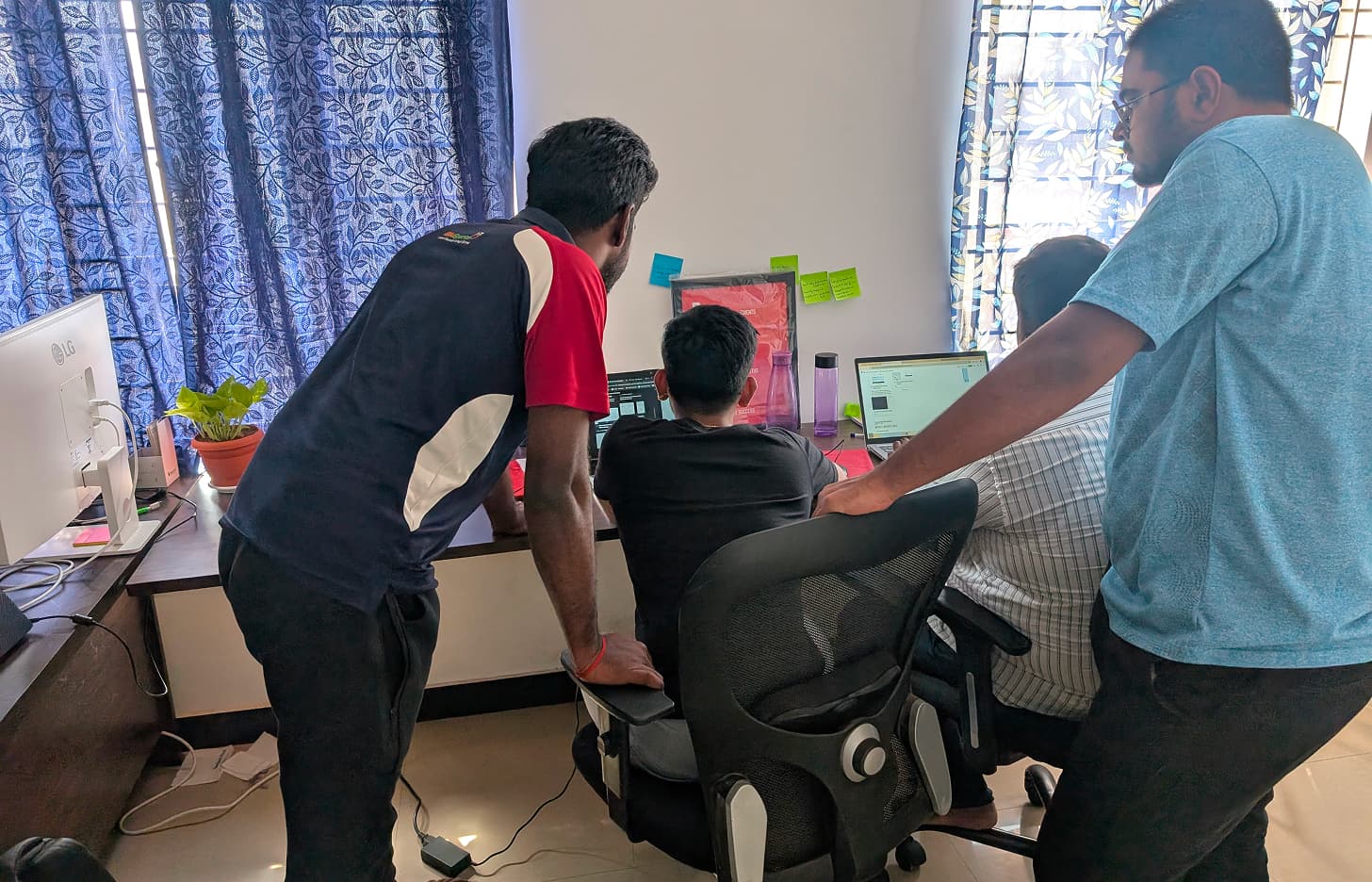 Early days: the team huddled around laptops in the first office