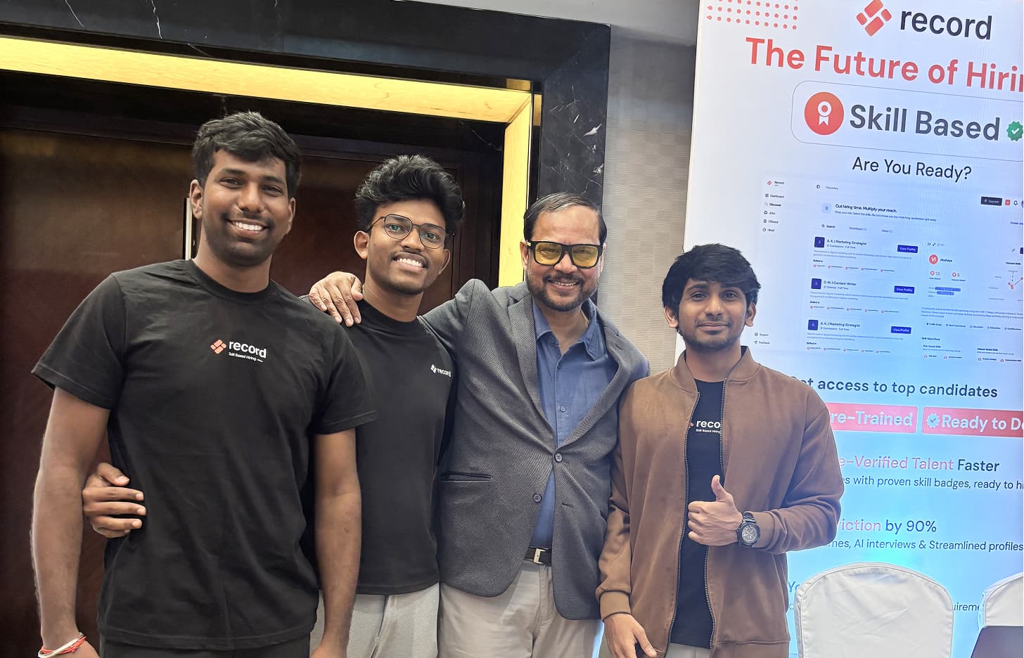 Team with a guest at the Record booth